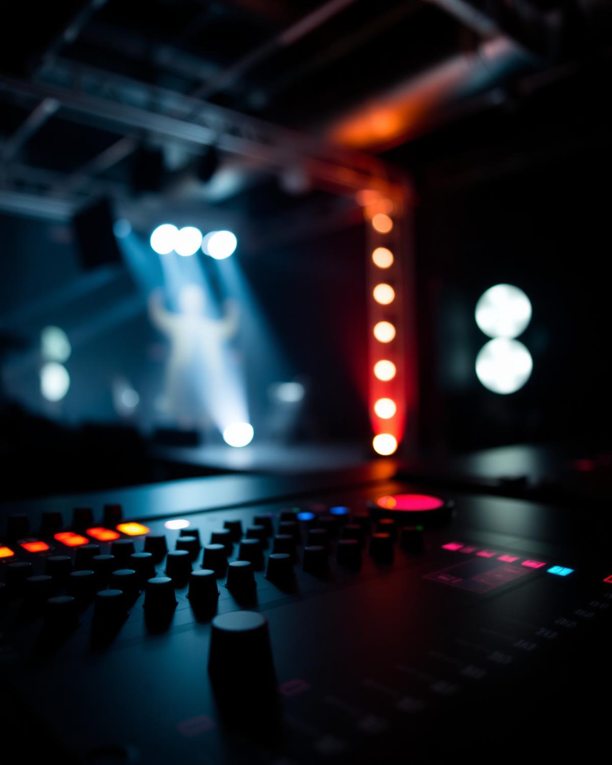DMX lighting console with blurred stage lights